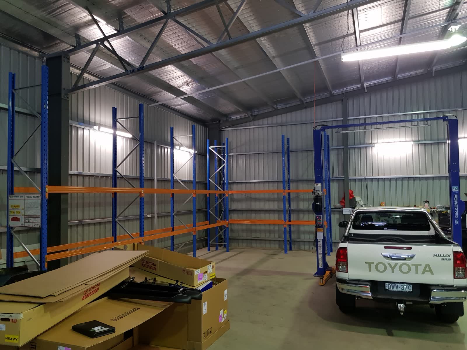 Cantilever racking storing long materials — bar stock, extrusions, or structural steel — in an industrial setting